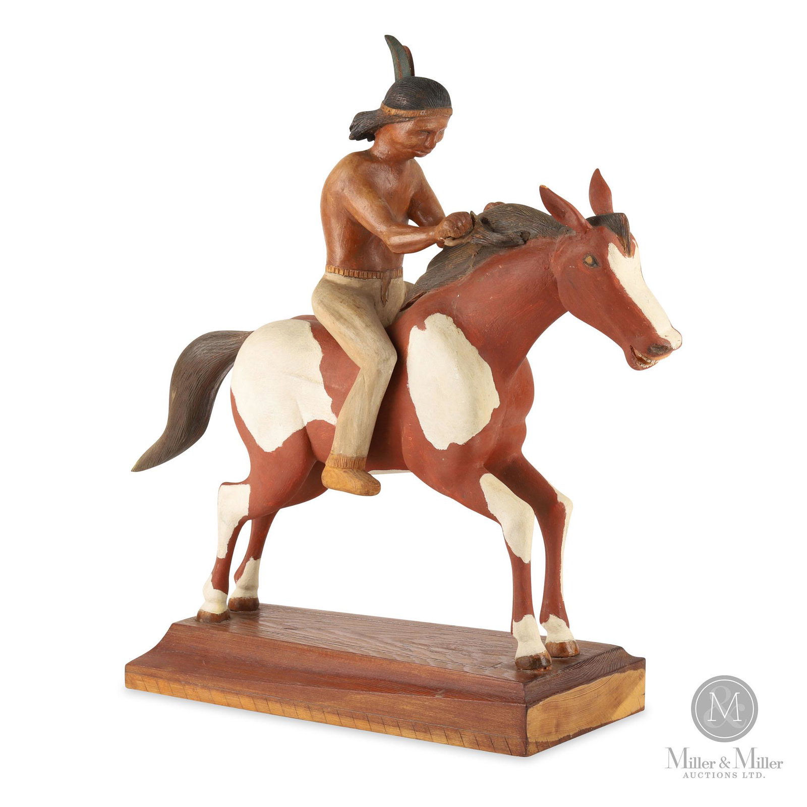 Carving Of A Native Man on Horseback by Charles Fournier: Canadian. Ca: 1970. Carved pine. A painted brown and white carving of a native man on horseback attributed to Charles Fournier of St. Anicet, Quebec. Mounted to its original unpainted pine base. Fourn