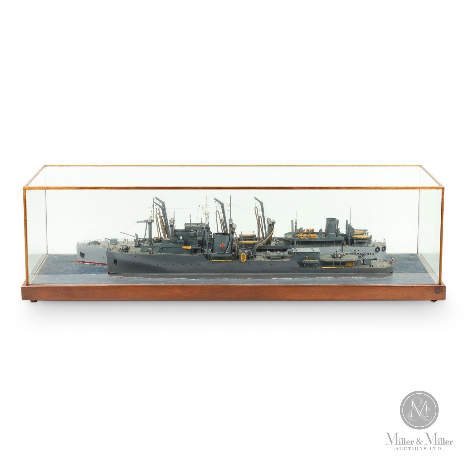 Diorama Of The Sinking Freighter M/V Montrose: Canadian. Mid-20th C. Mixed media (wood, metal). In original glass case. An extremely detailed model of two warships, one identified as the "Montrose" and the other bearing the Canadian flag. Mixed me