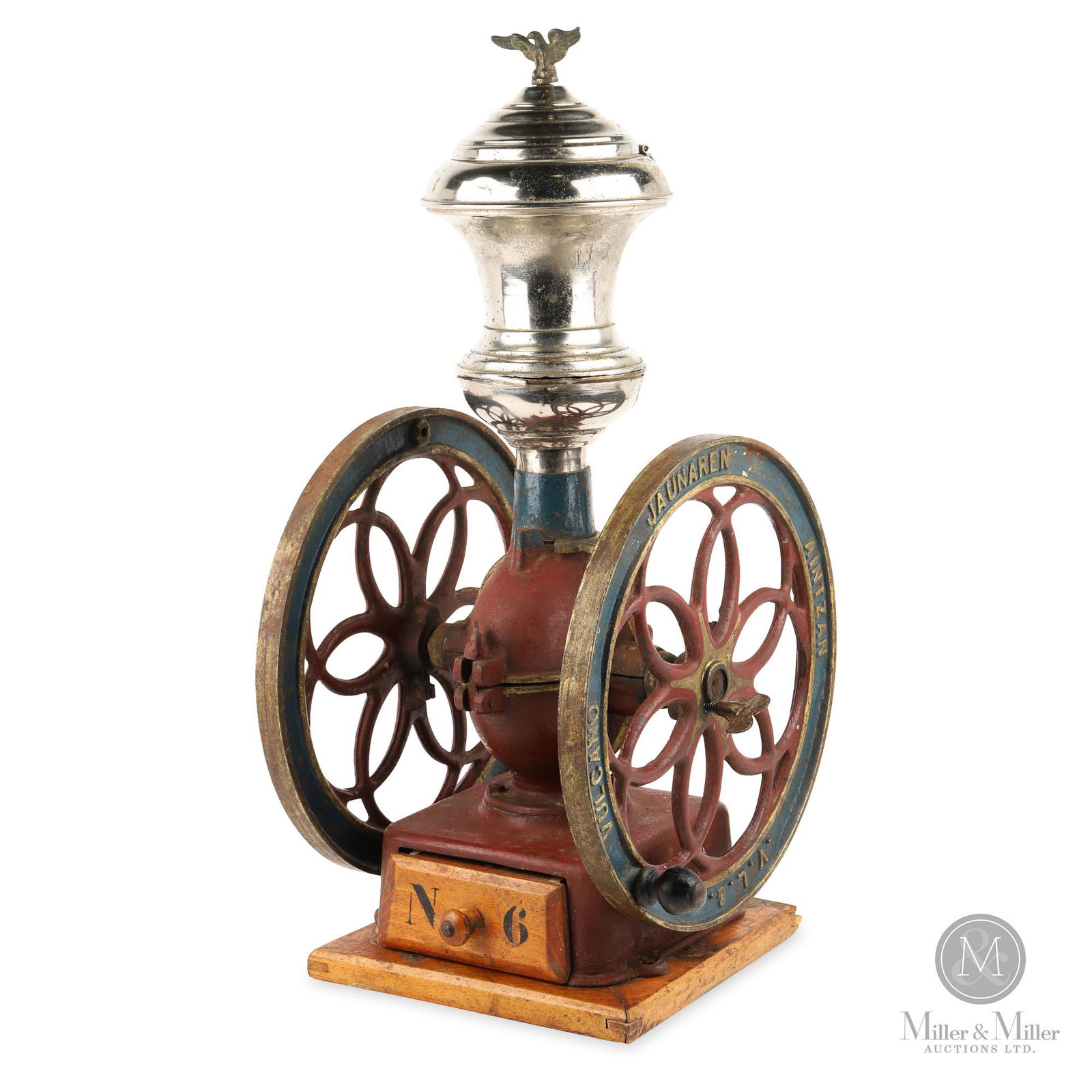 V.L. Vulcano No. 6 Coffee Mill: Italian. 1920s. Cast Iron with nickel plated bean hopper. Marked, "V.L. & Vulcano Jaunaren Aintzan No. 6" on each wheel. Original paint. Hopper exhibits scattered shallow impressions and minor oxidati