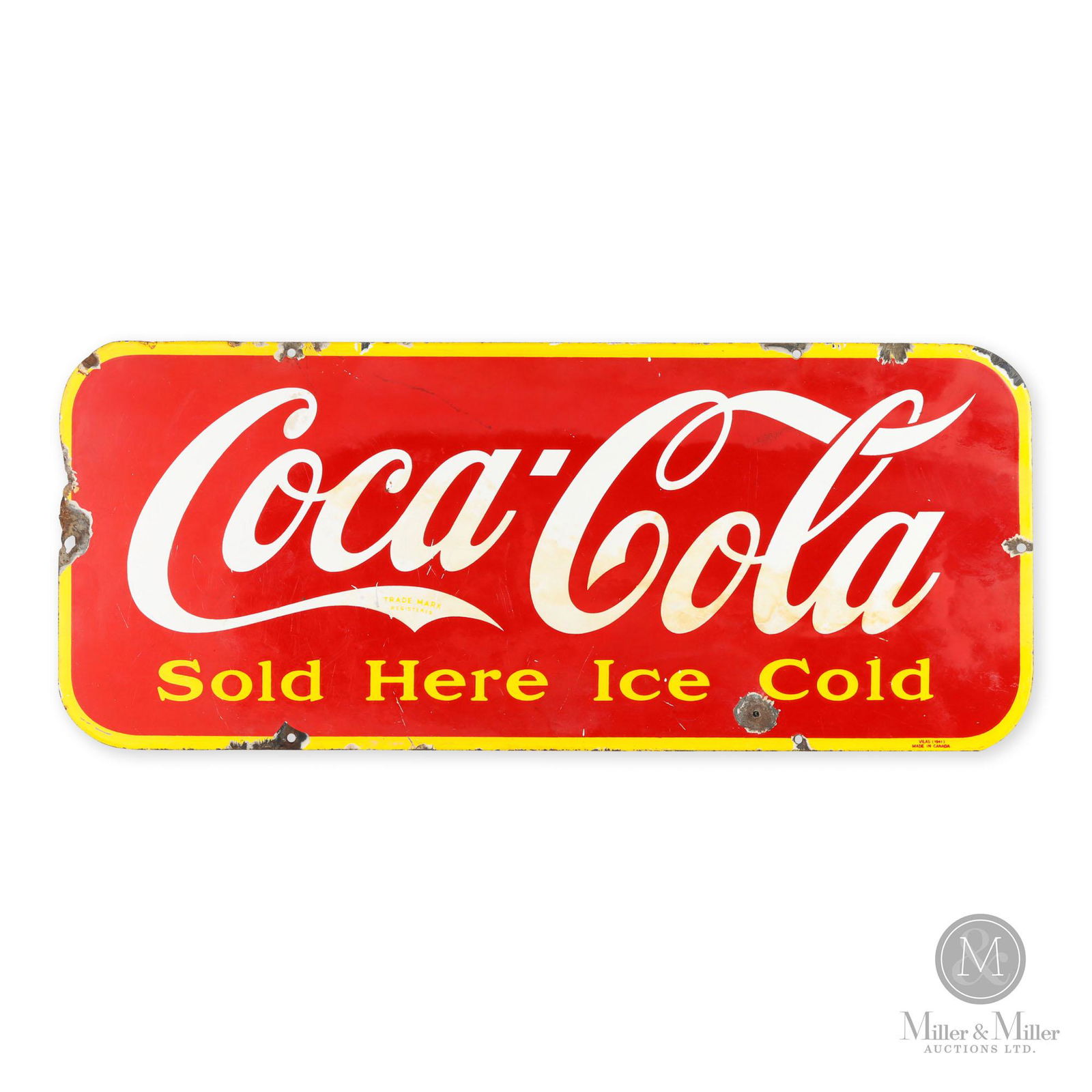 Coca-Cola "Kick Plate" Sign: Canadian. 1941. Single sided porcelain (SSP). Marked, "VILAS (1941) Made in Canada", lower right edge. Porcelain losses surrounding each of the factory mounting holes and from the extreme edges. An ad