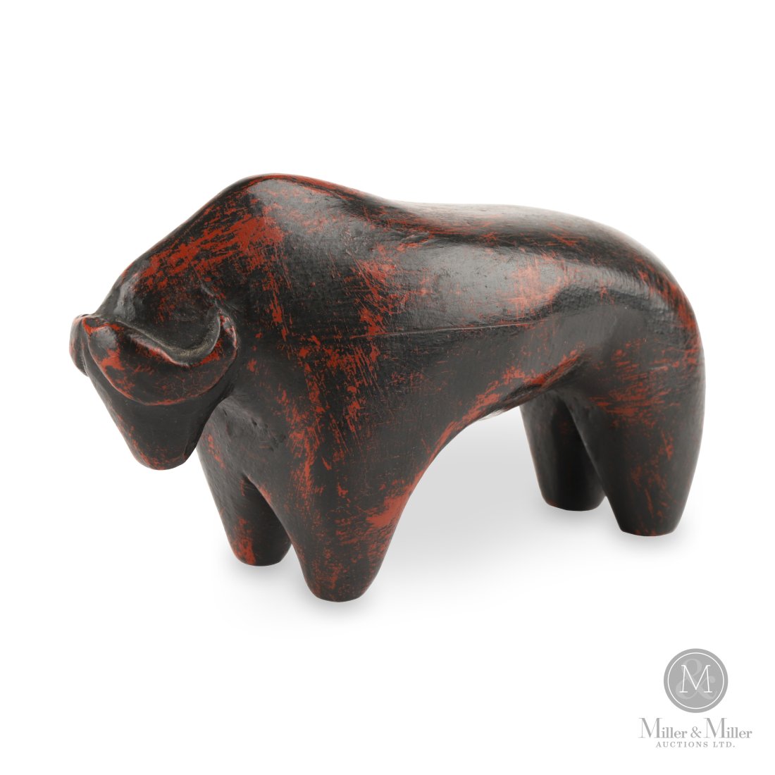 Grazing Buffalo by Robert Wylie: Thomasburg, Ontario. c1980. Pine. A hard to find smaller stylized carving of a grazing buffalo by acclaimed Ontario artist Robert Wylie in his typical distressed black over red paint. Note: The green