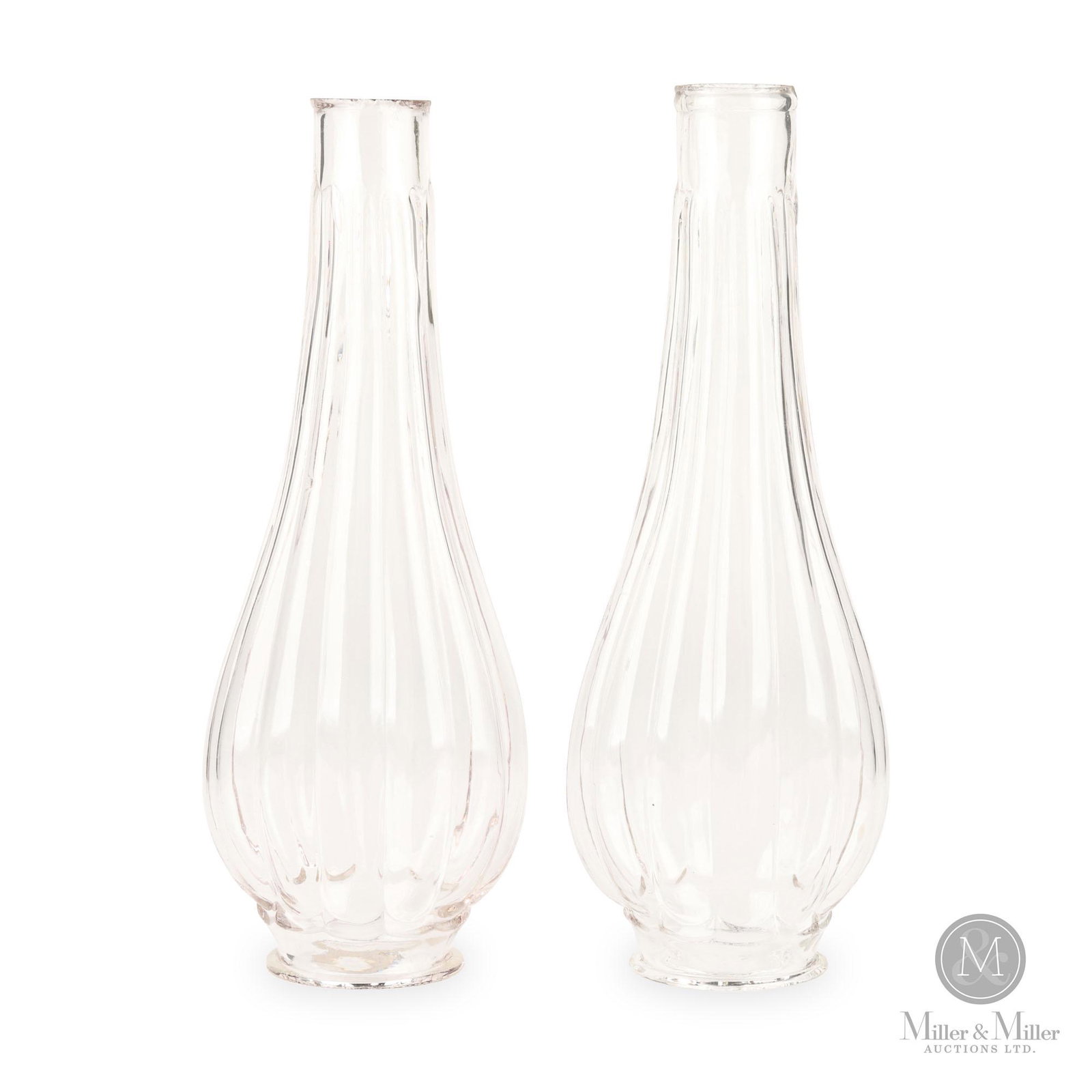 Pair of Molded Ribbed Lip Chimneys: Two (2). American. 1860-1880. Glass. Outstanding molded ribbed chimneys with rough cut top and base. From the Keith Dill Collection. 2 1/8” base diameter; 9 ½”H.