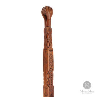 Highly Decorated Iroquois Carved Cane: North American. Hardwood. An Iroquois carved hardwood cane with the Chief's headrests and a native holding a tomahawk pipe, a dove of peace, and an anchor. The shaft culminates in two hands clasping a