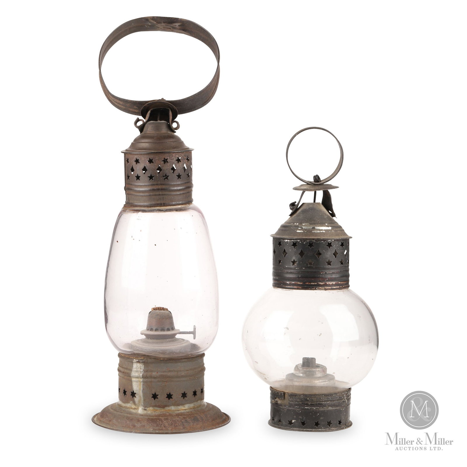 Pair of Early Whale Oil Lanterns: American. Tin and glass. Two early tin and glass oil lamps, each with bases and chimneys pierced with stars and diamonds and tin loop handles. The burners are intact. Lot 1: 11" x 5". Lot 2: 15.5" x 4
