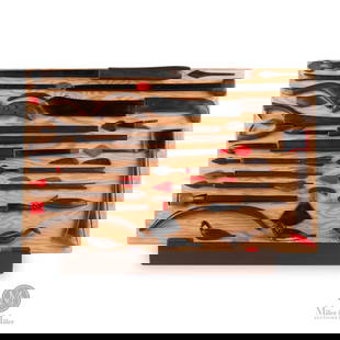 Wood Tableau of Traditional Hunting Tools: Yellowknife, Northwest Territories. Softwood. A tableau consisting of 31 wood carvings of traditional hunting tools painted in brown, black, or red. Including harpoons, arrows, bows, spears, hooks, ul