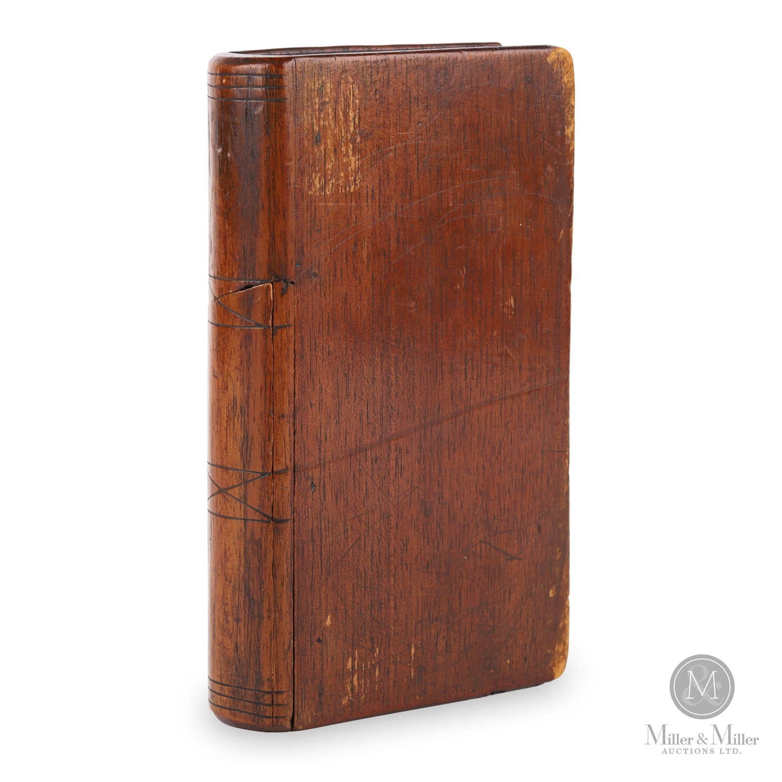 Canadian Maritime Book-Shaped Secret Storage Box: Canadian Maritimes. Late 19th century. Mahogany. Hollowed out book-shaped box used to store trinkets, money or anything of value. The book has incised lines to the "spine" and retains original old var