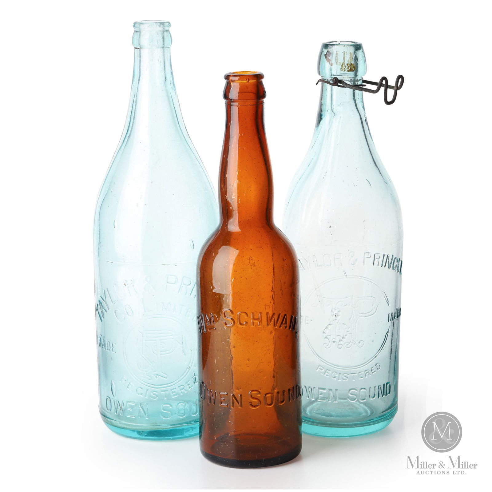 Owen Sound, Ontario Beer and Soda Water Bottles: Canadian. 1890s-1910s. Glass. 10.25" x 2.5" x 2.5", 10.75" x 3.25" x 3.25", and 11.25" x 3.5" x 3.5". From the William Robert Wilson Collection.