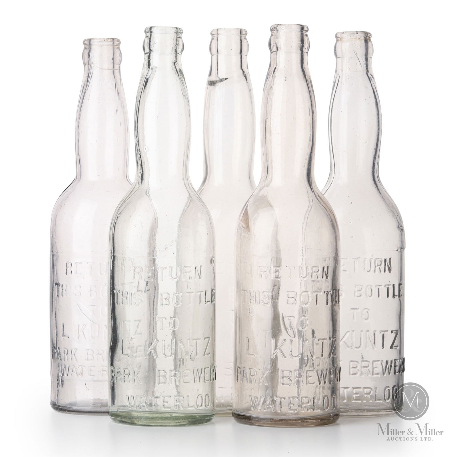 L. Kuntz Brewery Waterloo, Ontario Beer Bottles: Canadian. 1910s. Glass. Marked, "Waterloo", on bottom of each. 10.5" x 2.27" x 2.75" each. From the William Robert Wilson Collection.