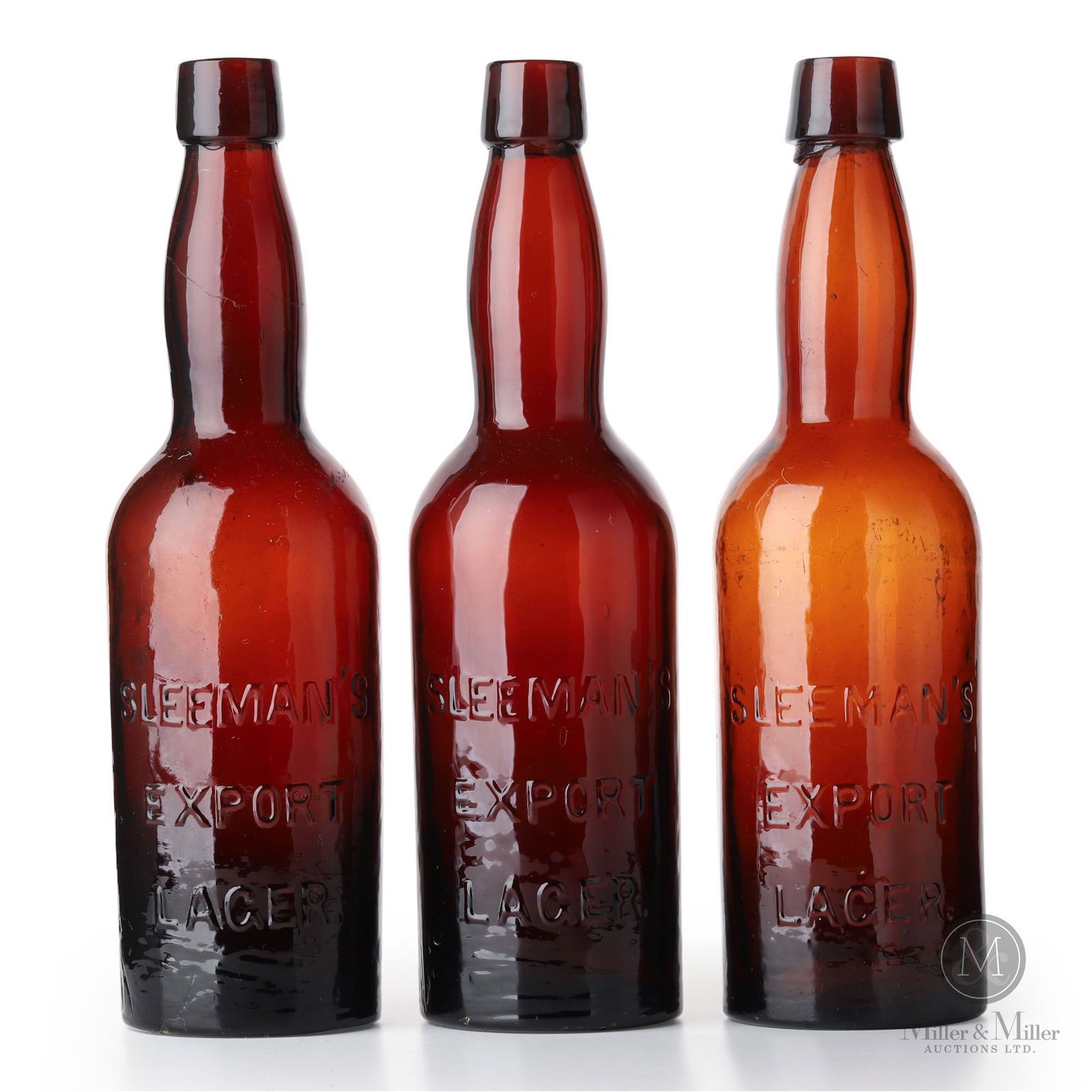 Sleeman Brewery Guelph, Ontario Beer Bottles: Canadian. 1910s. Glass. Two of the bottles are whittled. 10" x 2.5" x 2.5" each. From the William Robert Wilson Collection.