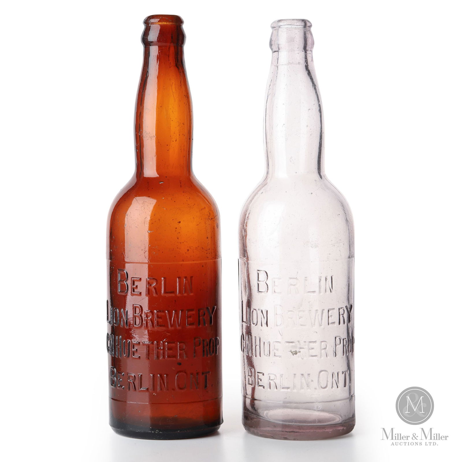 Berlin Lion Brewery Beer Bottles: Canadian. 1900s-1910s. Glass. 10" x 2.75" x 2.75" each. From the William Robert Wilson Collection.