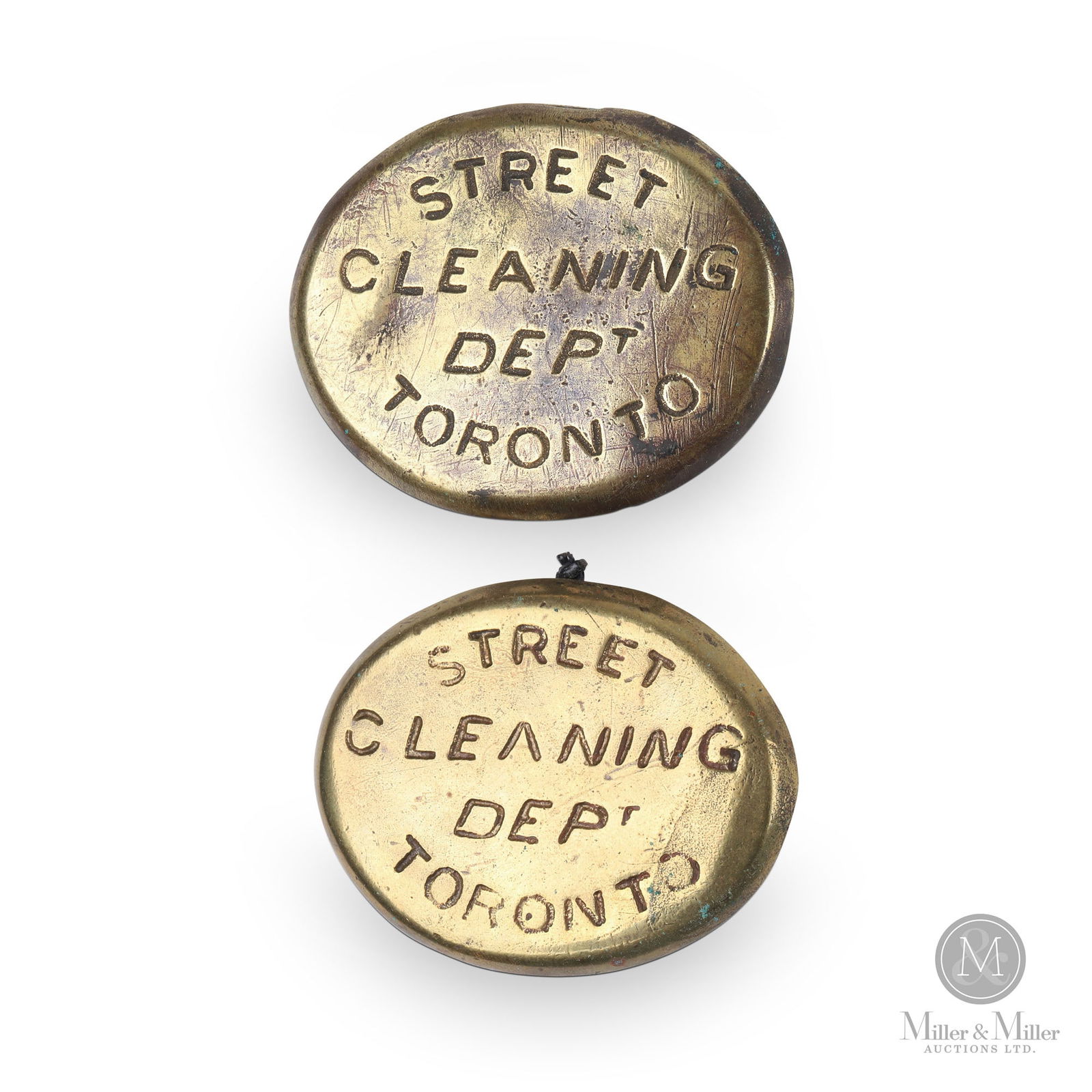 Toronto Street Cleaning Department Curb Tags: Canadian. 1910s. Brass. Each: 2.25" x 2.75". From the William Robert Wilson Collection.