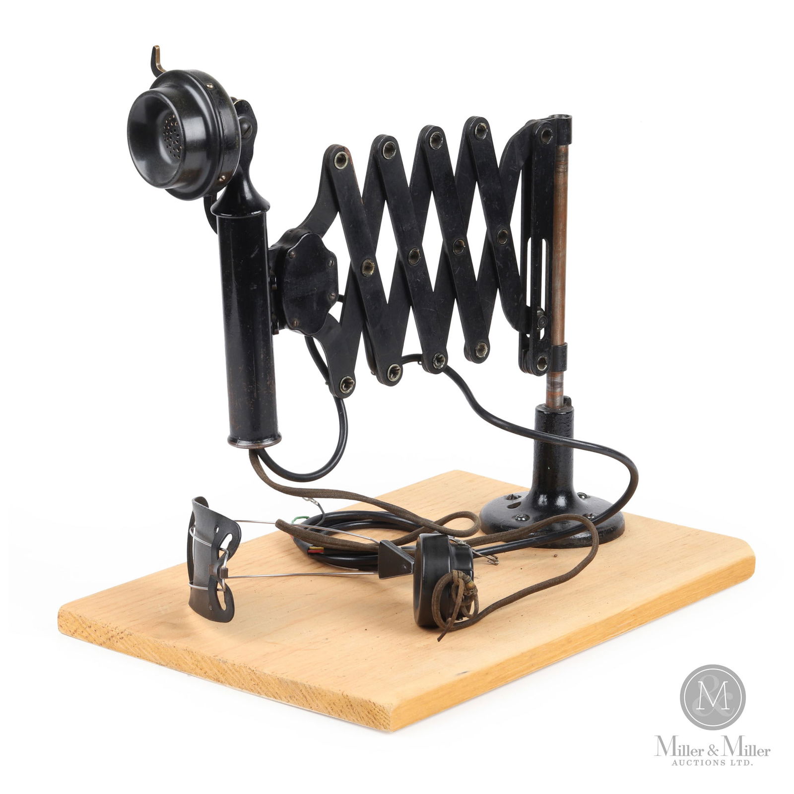 Western Electric Scissor Mount Desk Phone: Canadian. 1930s. Metal with bakelite components. Marked, "Western Electric", on the earpiece. 13" x 12" x 5". From the William Robert Wilson Collection.