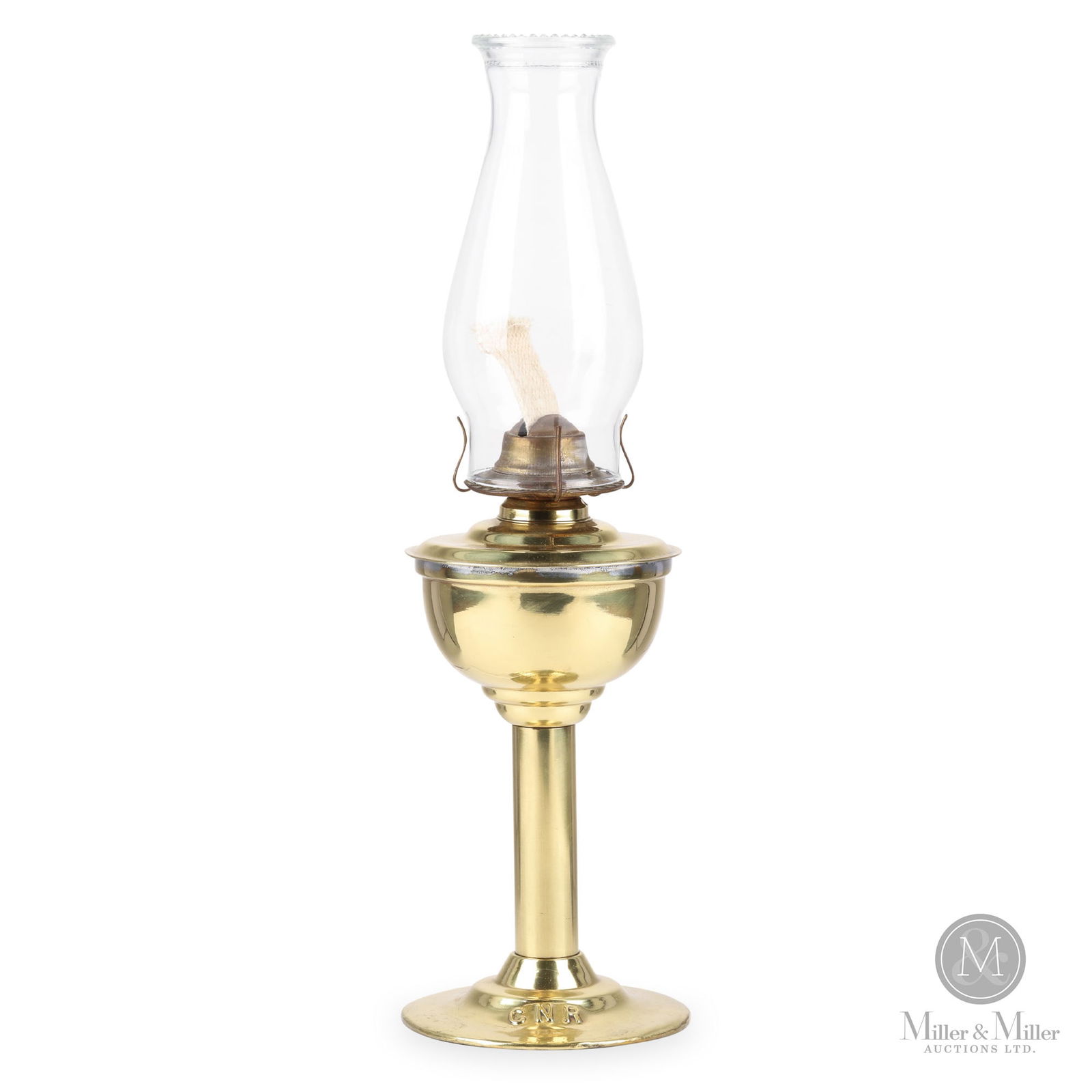 H.L. Piper Canadian Northern Railway Station Desk Lamp: Canadian. 1910s. Brass with glass chimney. Marked, "Piper Montreal", on top of fount. Marked, "CNR", on top of base. 12" x 5.5" x 5.5" (not including chimney). From the William Robert Wilson Collectio