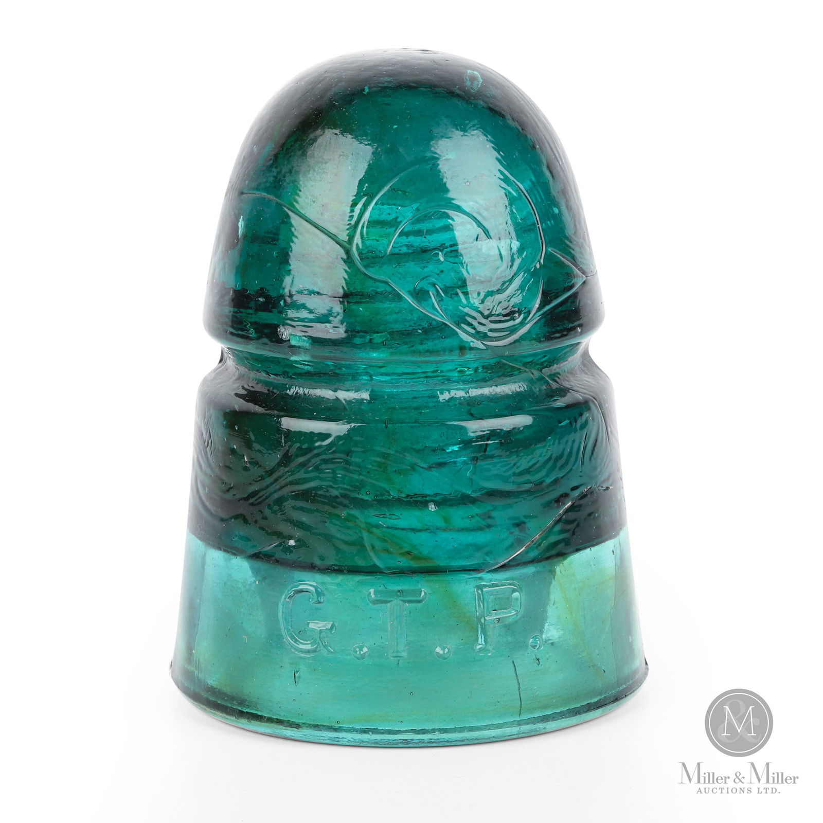 Grand Trunk Pacific CD145 Insulator: Canadian. 1910s. Glass. Marked, "G.T.P.". 4.25" x 3" x 3". From the William Robert Wilson Collection.