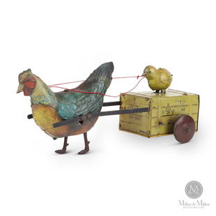 Hans Eberl Gik-Gak Rooster Pulling Chick on Wood Crate: German. 1910-1920. Lithographed tin. Marked, "EBO", "GIK-GAK", and "HEN", on all sides of crate. Marked, "43", on two sides of crate. 4.75" x 9.25" x 4.25". From the Darryl Silver Collection.