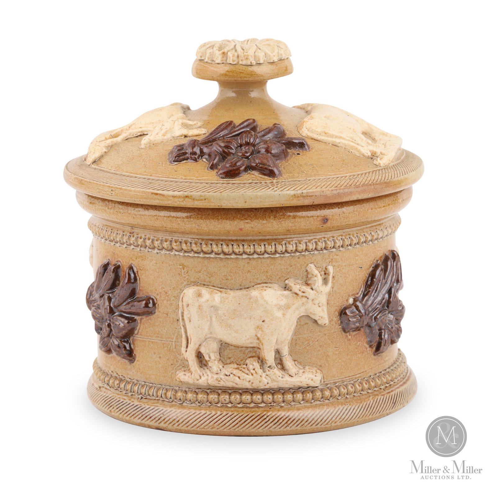 English Tobacco Humidor: English. 19th century. Stoneware. This stoneware humidor shows applied sprigging in brown and cream-coloured cattle around the body and lid. 5" x 5" x 5".
