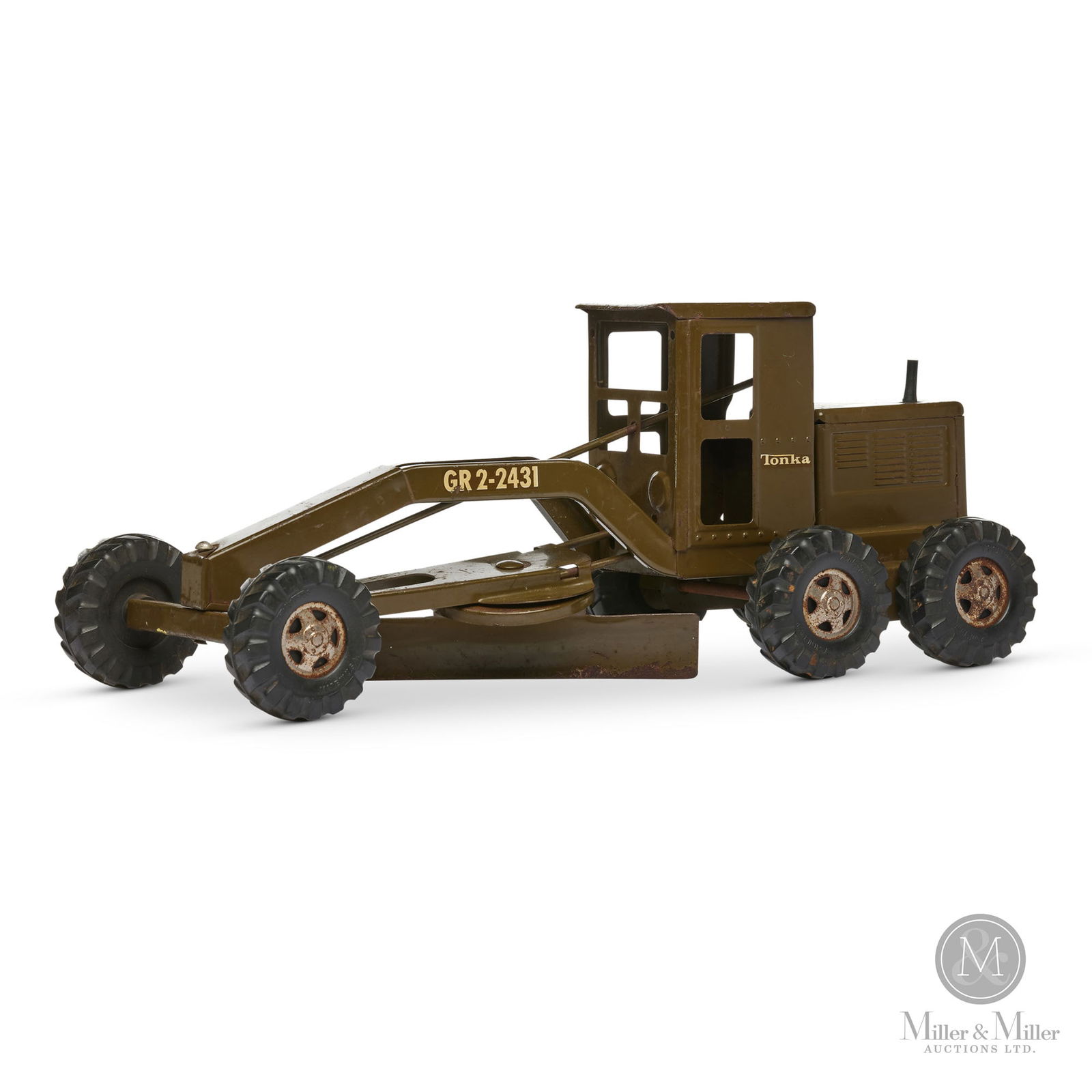 Tonka No. GR2-2431 U.S. Army Road Grader: American. 1940s. A rare caterpillar truck. Has the U.S. Army "star" on top of the rear motor cab. Marked, on sides of cab and rubber tires. Size 7" x 17" x 7". Condition Retains original rubber stack.