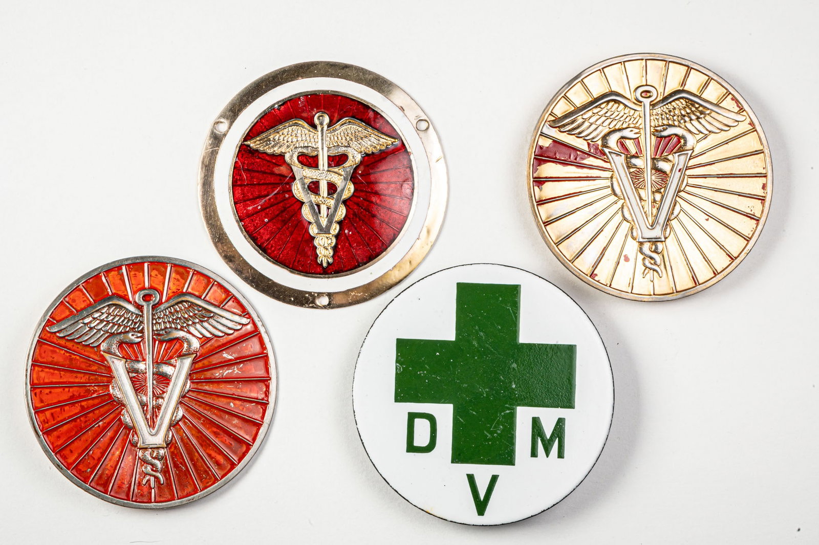 Veterinarian Automobile Badges: American. 1940s and 1950s. Size 3.5" to 3.75" Dia. Condition One shows near-complete paint loss. Medium Stamped metal, enamel, porcelain.