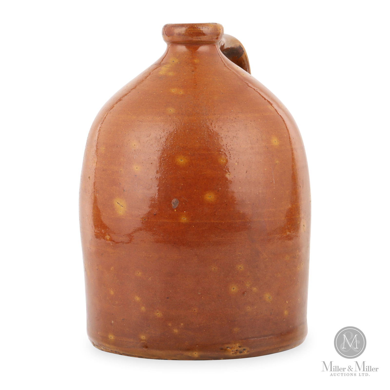 Ontario 1-Gallon Redware Jug: Ontario. 1870s-1880s. Earthenware. A lovely redware jug with its reddish-orange glaze and light orange starbursts throughout. Likely of western Ontario origin. Ex-Don Savage collection. 11" x 7.5" Dia