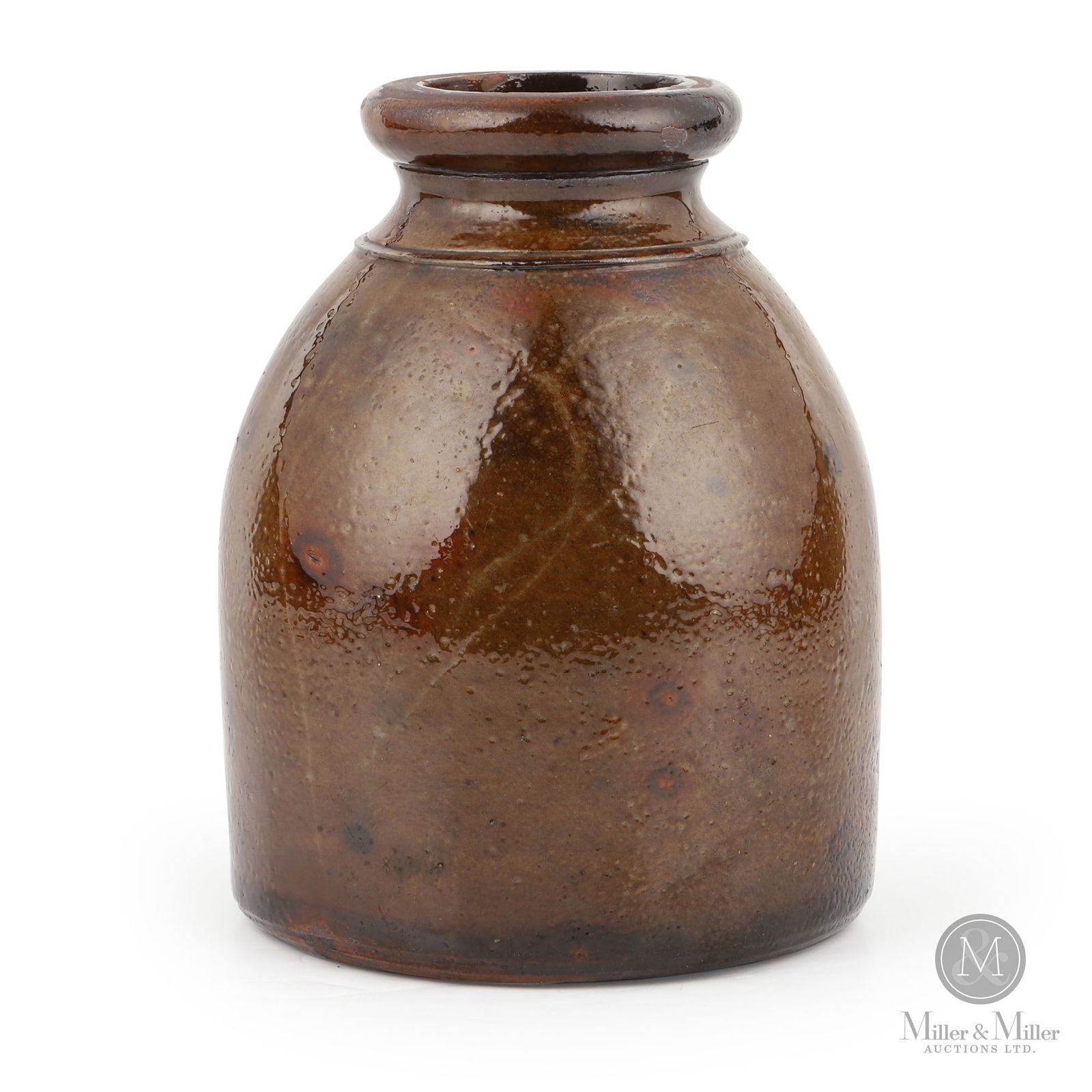 Western Ontario Half-Gallon Redware Jar: Ontario. 1870s-1880s. Earthenware. A wonderful variegated green glaze with splashes of orange, over a red clay body. A classic Western Ontario jar form, possibly Waterloo County. 8" x 5.75" Dia. From