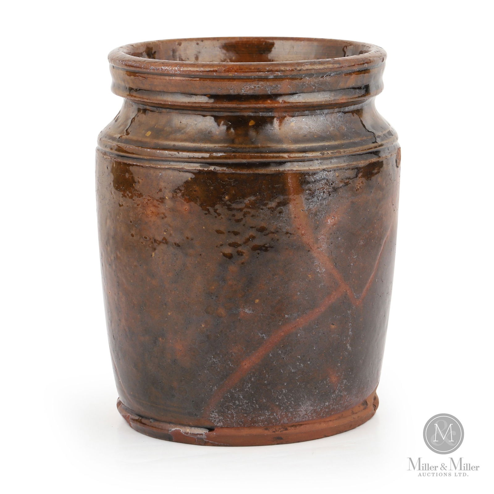 Ontario Quarter-Gallon Redware Jar: Ontario. 1860s-1880s. Earthenware. A fabulous little jar with a most unusual rim and shoulder profile. A muted dark green glaze with heavy veining. 6" x 4.75" Dia. From the Jon Church Collection.