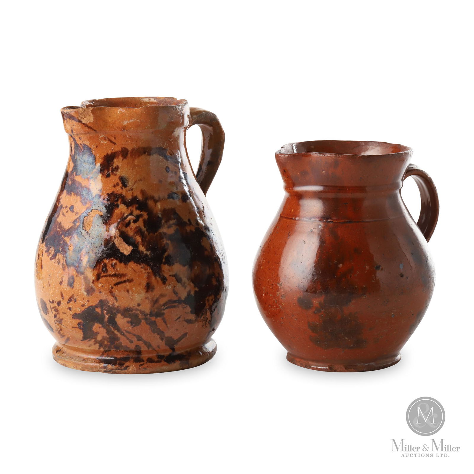 Two Redware Pitchers: Lot 1: likely Ontario. Lot 2: American. 1860s-1880s. Earthenware. This lot offers two redware pitchers, possibly by Germanic potters, each with a lovely bulbous form and padded base. Both have a clear