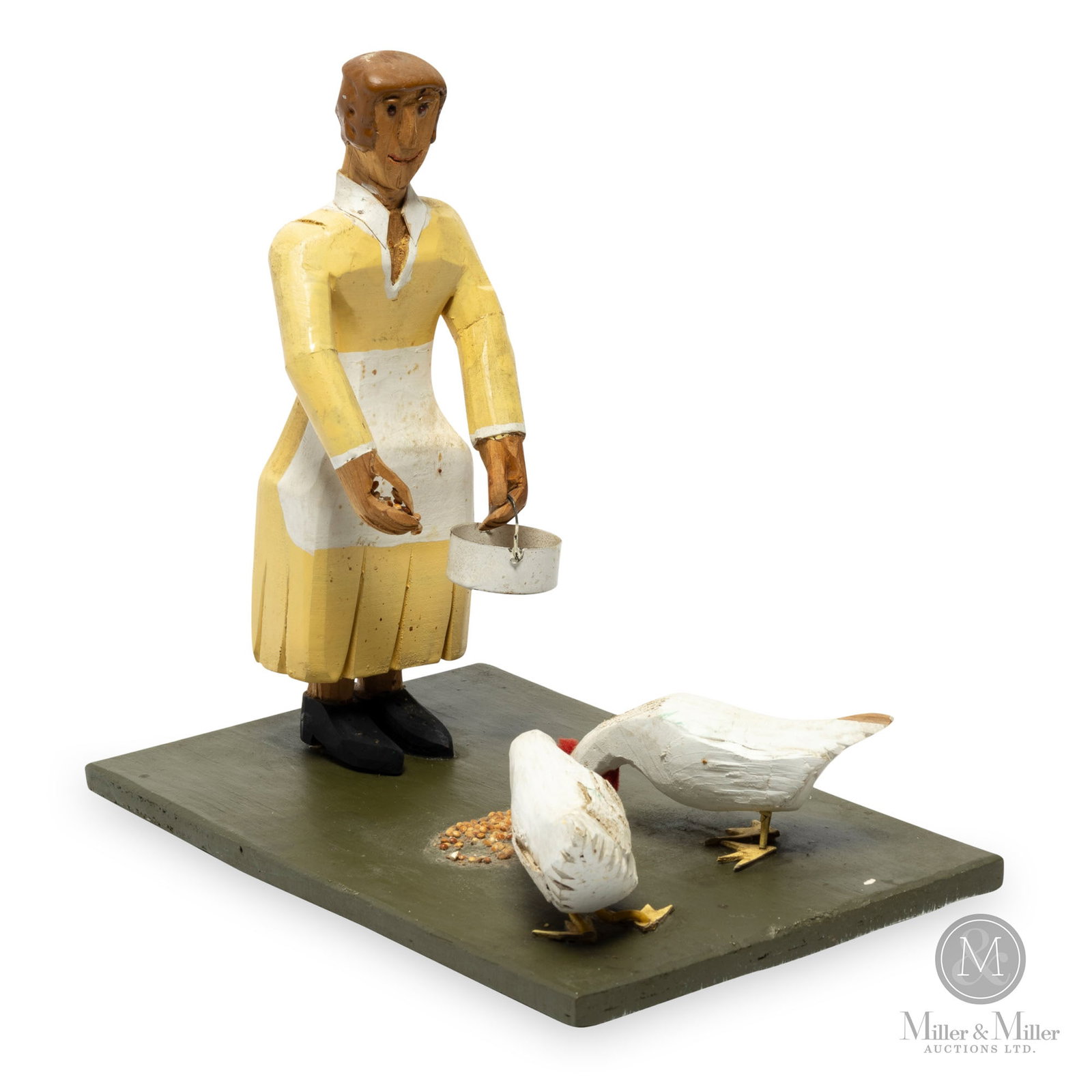 Woman & Chickens by Leslie D. Lush: Glenwood, Newfoundland. Mid 20th century. Carved and painted wood with a reutilized tiny tin pan. It is somewhat rare to see carvings from Newfoundland, such as this charming scene of a woman feeding 