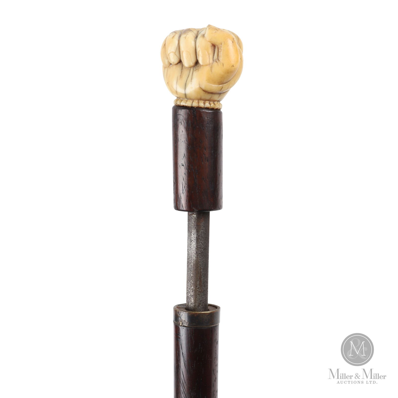Closed Hand Over Snake Sword Gadget Walking Stick: American or British. 19th century. Bone, hardwood, steel, bronze. Sword stick with a bone handle carved as a fist grasping a snake. The plain shaft with dark mahogany stain finish. With steel blade of