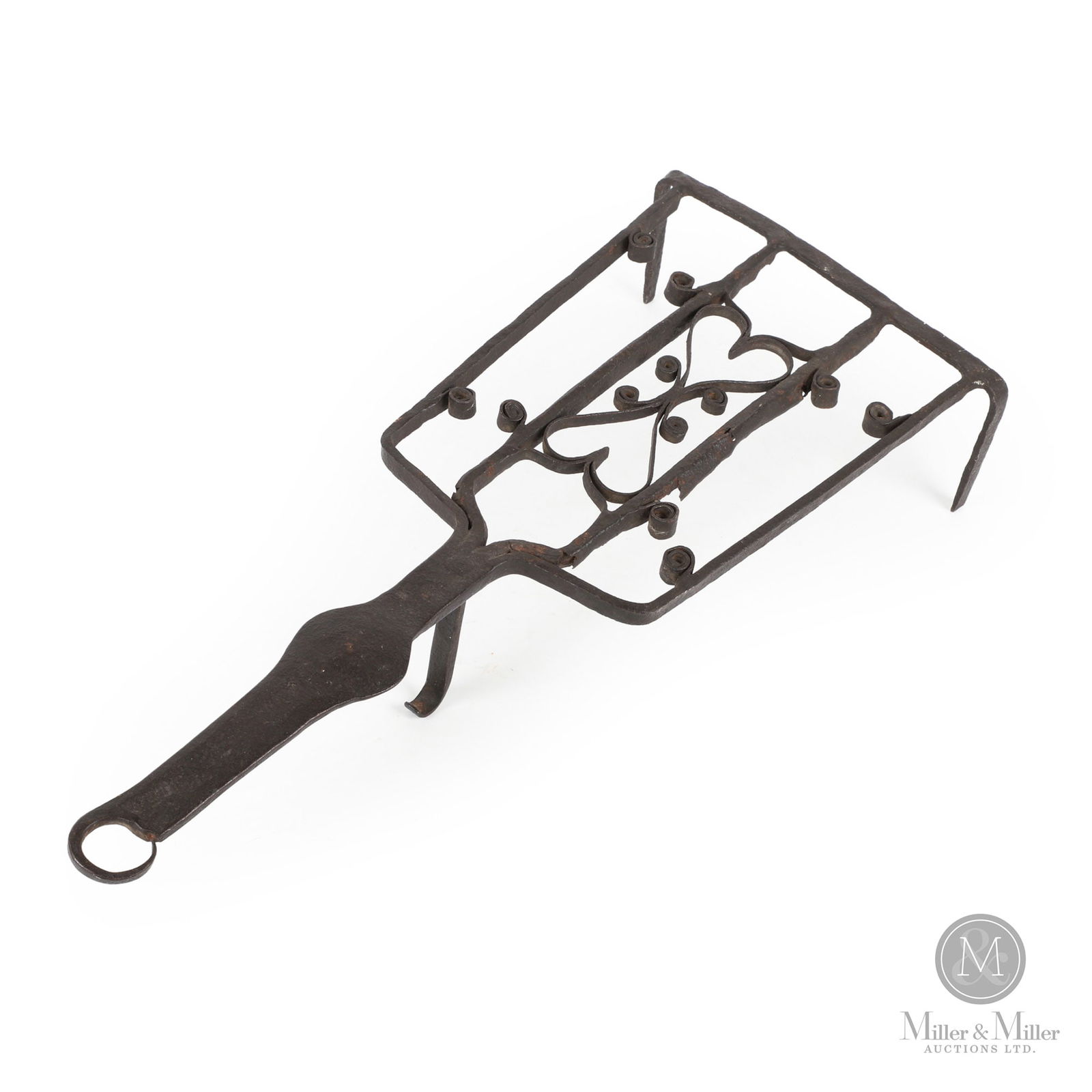 Forged Trivet With Hearts: , A hand wrought trivet resting on three legs with a flat shaped handle and the square grill having double hearts and scrolls. Ontario, early 19th century. 3.5" x 19.5" x 8". From the Tom & Cliff Stan