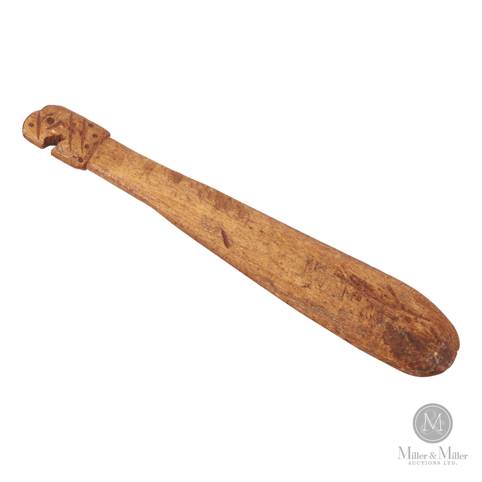 Makah Thunderbird Club: A Makah flat club or tool with a thunderbird head as a handle. Carved in fossilized whale bone, 19th century. 20" x 3.5" x 0.75". Found in Salt Spring Island BC.