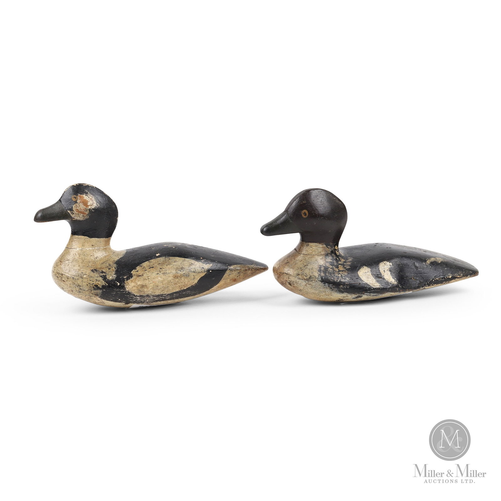 Goldeneye Pair - Sam Hutchins, Jones Falls Ontario: Jones Falls, Ontario. First quarter 20th century. Painted wood. Marked, "S", serrated on bottom of each. 6" x 12" x 4.25" and 5.5" x 11.5" x 5".