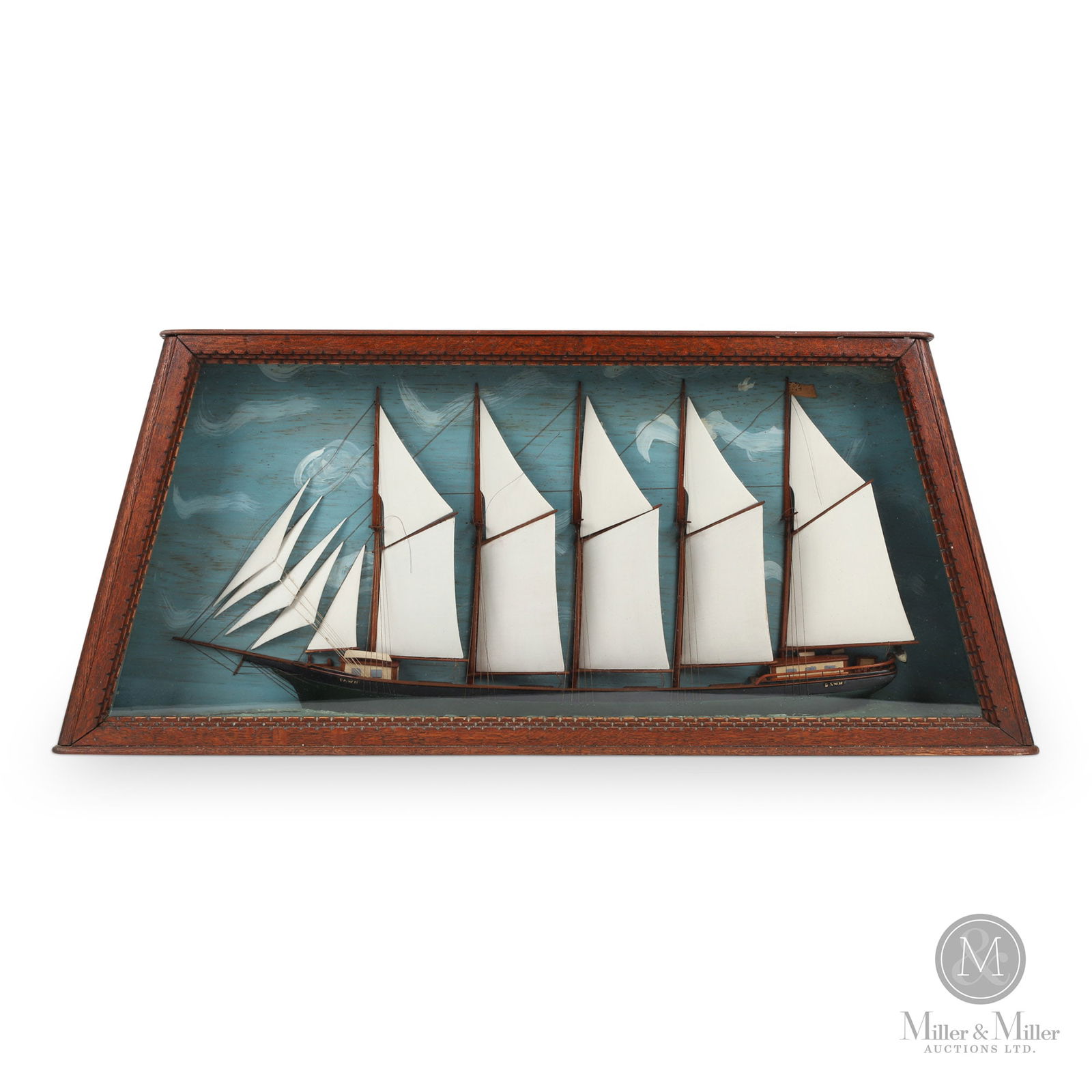 Unusual Diorama of Tern Schooner: An unusual diorama with a five-masted tern schooner in a cant-sided, panelled and moulded oak case. Finely made and in very good condition, the "Dawn" has the original varnished deck and a black and g
