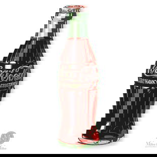 Coca-Cola Die Cut Bottle Sign: American. 1950s. Die-cut single-sided porcelain (SSP). Bottle shape, possibly for use as a door push. Authenticated by The Authentication Company (TAC #500571). From the Don Titherington Collection. S