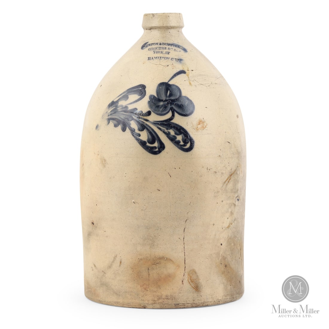 Murton & Duffield, Hamilton CW Large Jug: Canadian. 1849-1857. Murton & Duffield jug from Hamilton, Canada West. A large, likely 4 or 5 gallon piece. The unusual single flower is probably from the Morton & Co Brantford Pottery. The blue on
