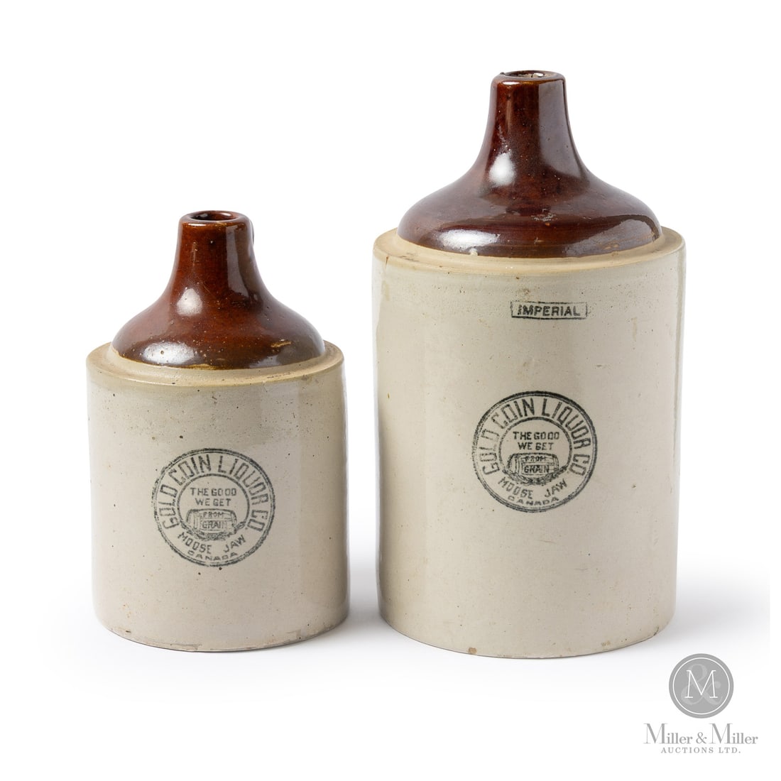 Gold Coin Liquor Co., Moose Jaw Pair: Canadian. 1905-1915. A pair of jugs from the Gold Coin Liquor Company of Moose Jaw, Saskatchewan. Note the trademark barrel with "The Good We Get from Grain". Two scarce small-town crocks.Size1