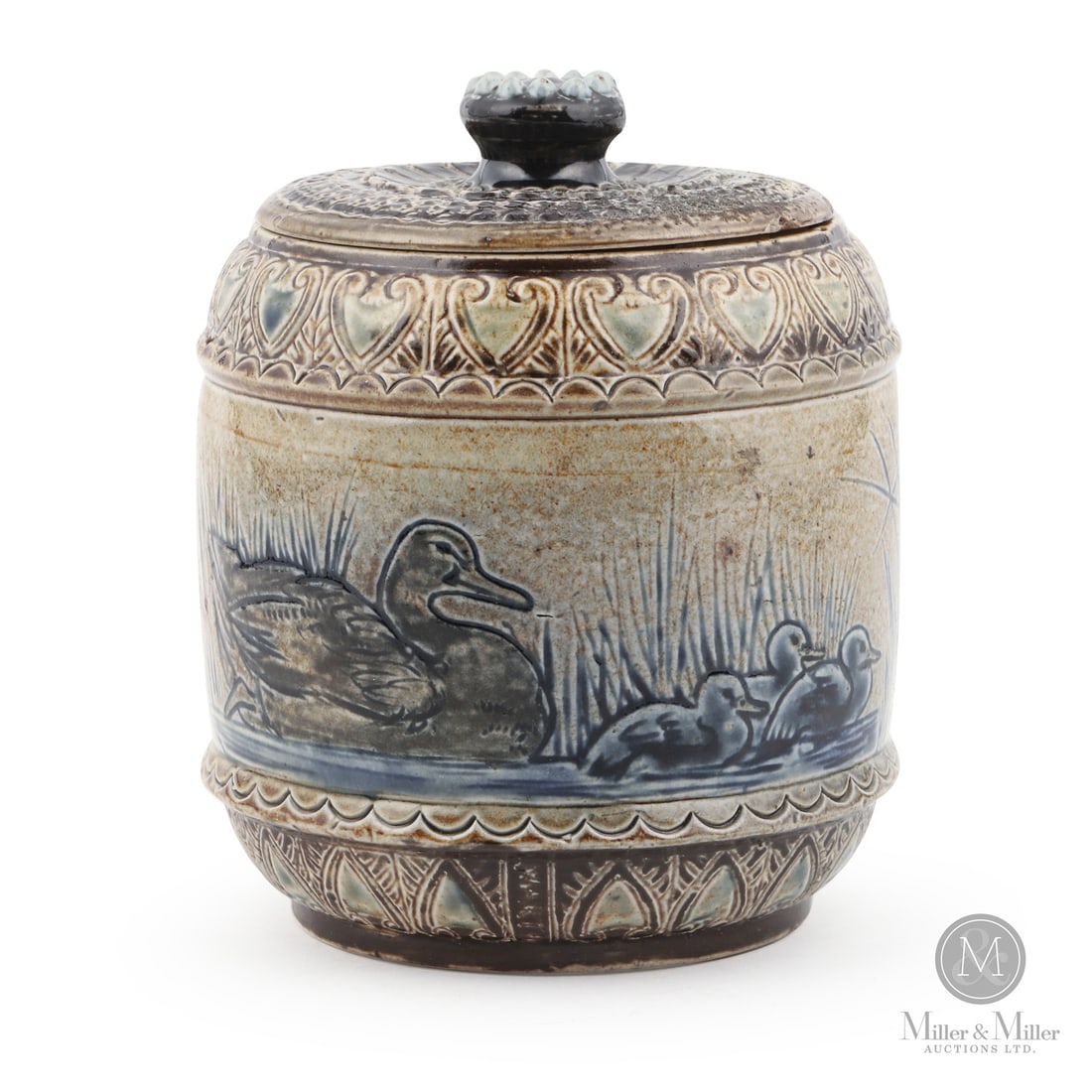 Martin Brothers Ducks Covered Jar: British. 1875. A Martin Brothers covered jar with a lovely scene of a mother duck and ducklings. Heavy geometric patterning and attractive multi-coloured salt-glazing. Marked, "12 1875 RW Martin Bros