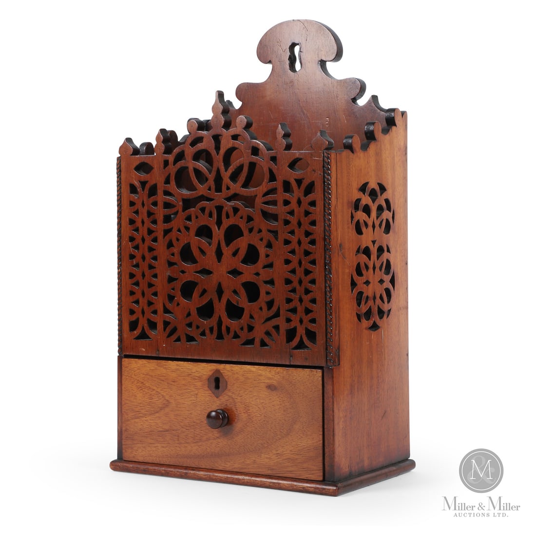 Lunenburg Nova Scotia Spill Box: Canadian. Wood. A hanging mahogany wall box with a fret cut front panel and a drawer below, from Lunenburg, Nova Scotia. The backboard, sides and front have a decorative scroll cut edge, and the sides