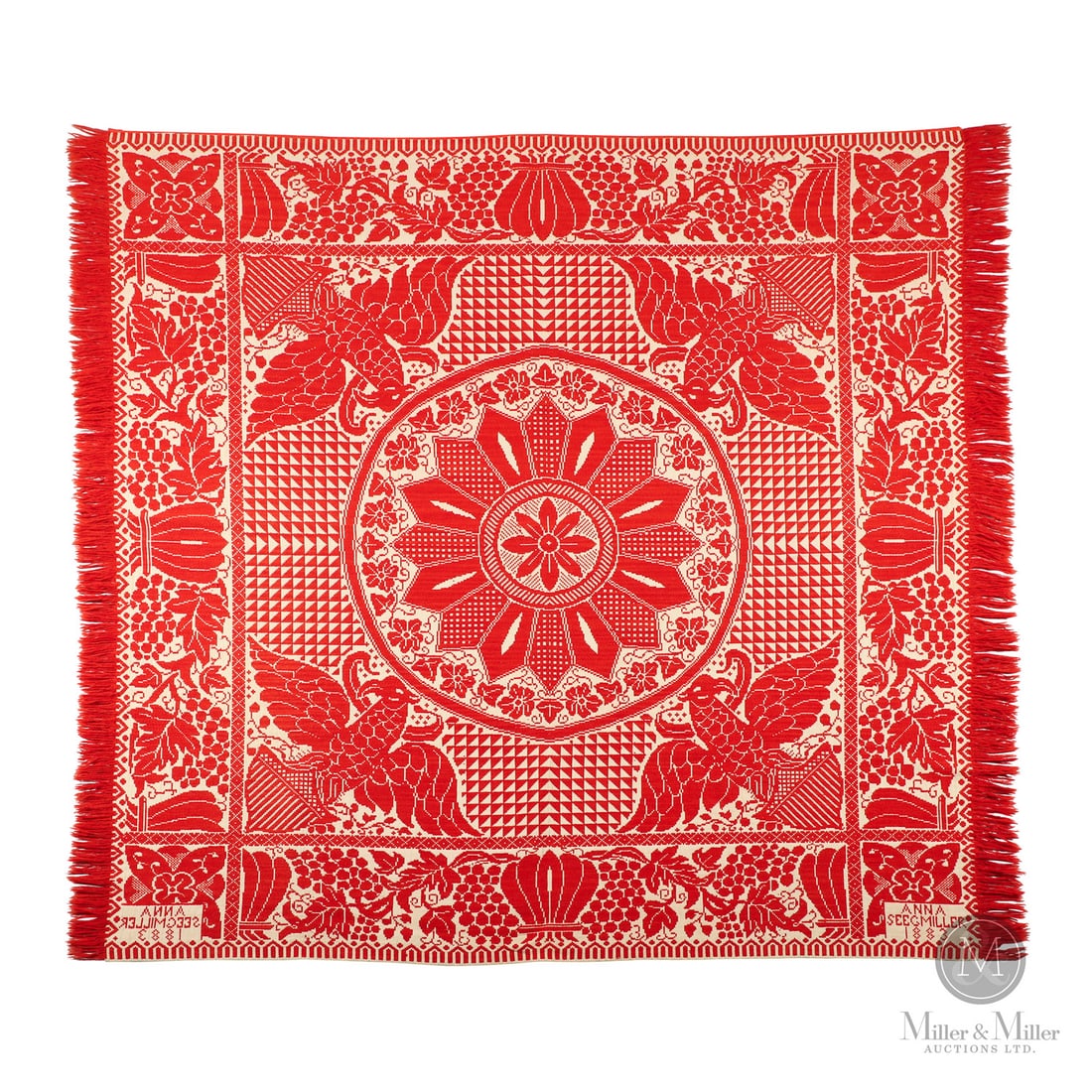 Eagles and Shields Signed Coverlet: Canadian. Wool, cotton. A one-piece red and white Jacquard coverlet signed and dated in a corner on each side "Anna Seegmiller 1883", having four eagles with shields surrounding a centre medallion.