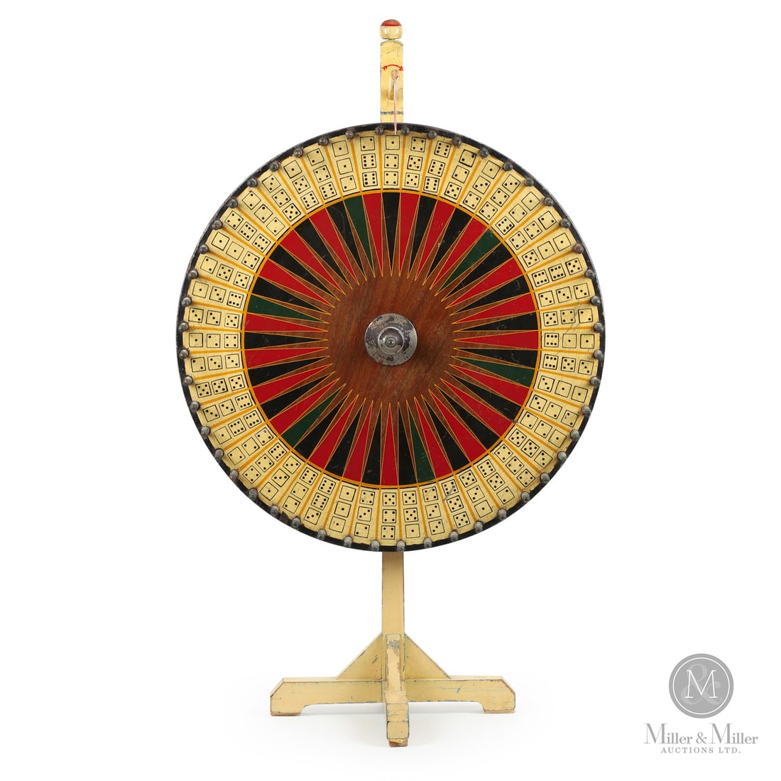 Carnival Wheel On Stand: Canadian. Wood. A carnival wheel on a stand with strong visual appeal, having excellent polychrome paint and design in yellow, black, green, and red. In very good condition with the original