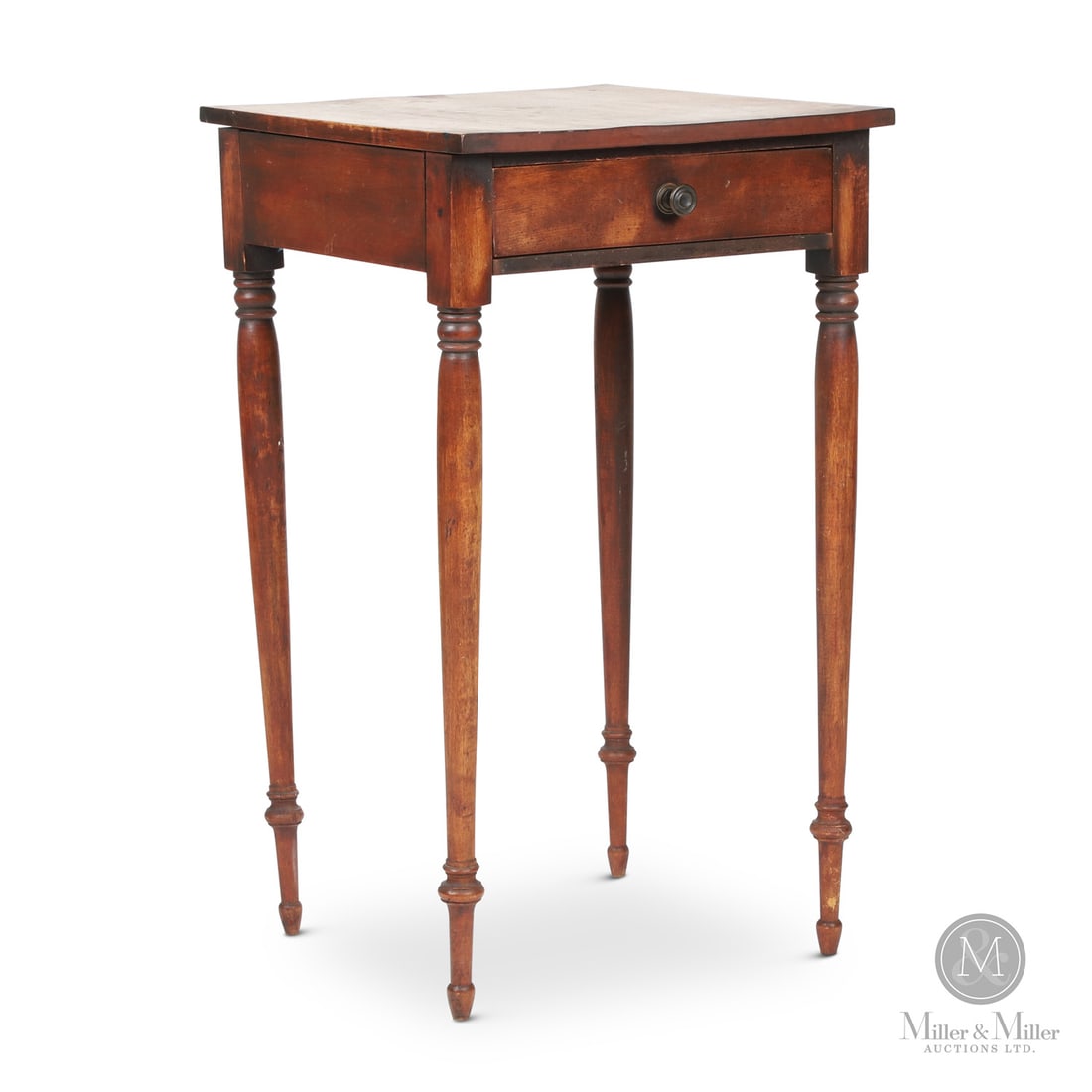 Lunenburg County Lamp Table: Canadian. Wood. A one-drawer birch lamp table from Bridgewater, Nova Scotia (Lunenburg County) in dry original varnished surface with finely turned legs. Very good condition, dovetailed drawer with pi