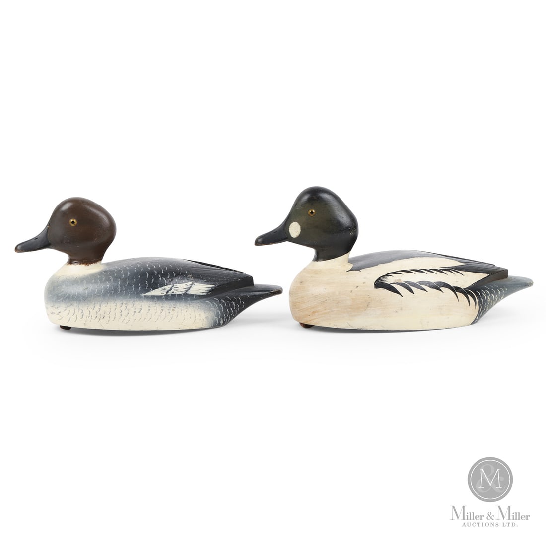 Reg Blume (1916-2005), Kingston, Ontario, Goldeneye Decoys: Kingston, Ontario. 1960s. Painted wood. Larger: 6.5" x 6.25" x 14.25". Smaller: 6" x 5.5" x 12.75". Kingston, Ontario. 1960s.