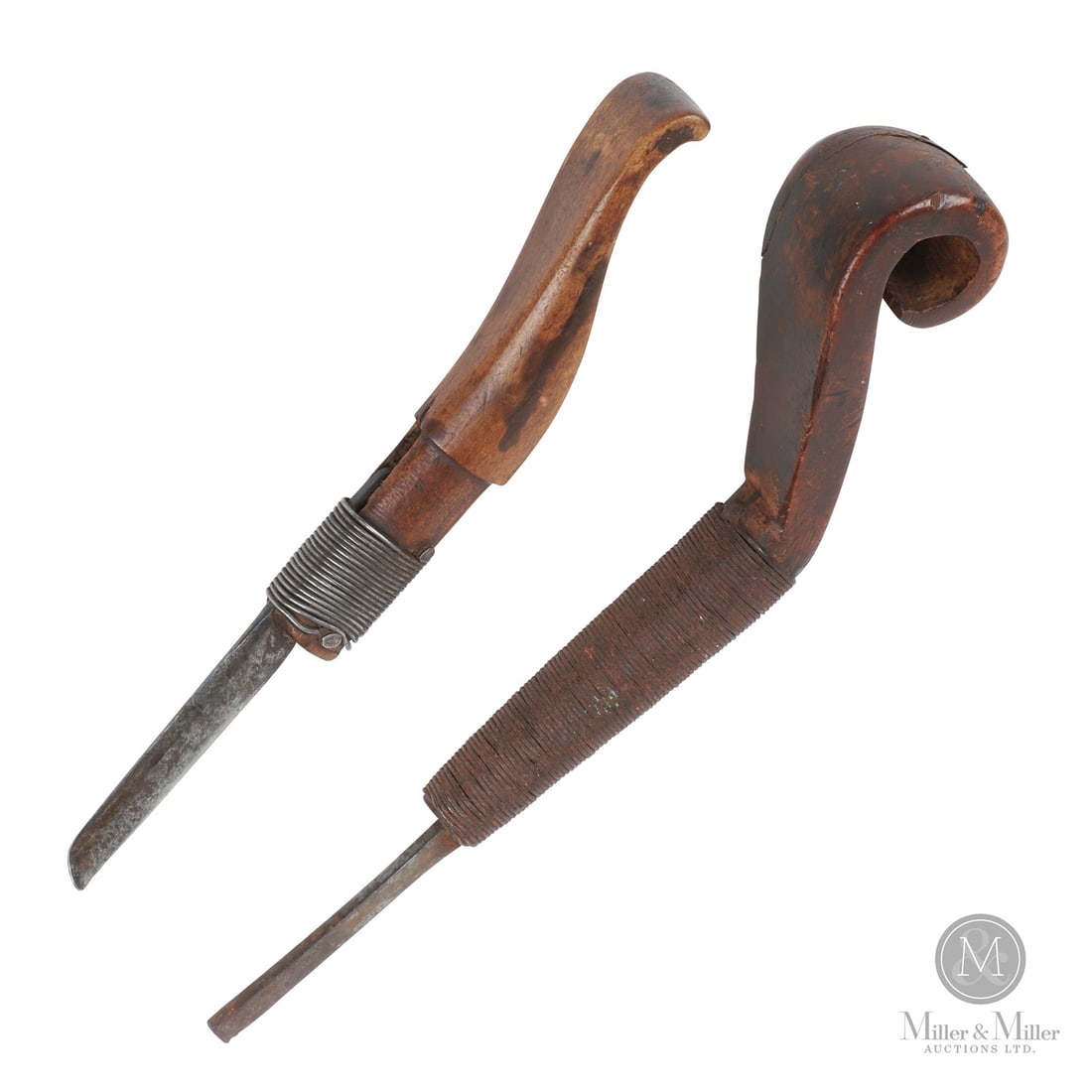 Two Scroll Handle Crooked Knives: Canadian. Wood, metal. A lot of 2 crooked knives, one with a volute carved handle and dark patina and the other with good ergonomic form and warm patina. Both retain old tightly wrapped wire to hold t