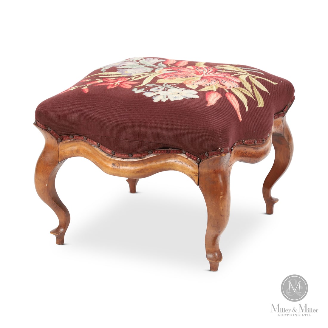 Cabriole Leg Stool: Canadian. Wood. A cabriole leg upholstered stool with a serpentine-shaped skirt. Constructed in cherry with a pine bottom board, refinished. Canadian, 19th century. 17" x 23" x 23". From the Jon and