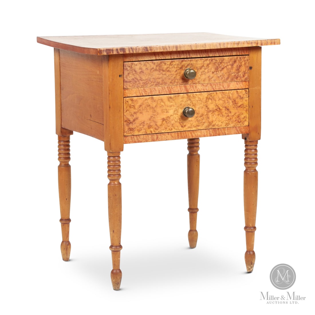 Figured Maple 2-Drawer Table: Canadian. Wood. An Ontario two-drawer maple lamp table with turned legs and a tiger maple top and solid birdseye maple drawer fronts. Dovetailed drawers. In refinished condition with minor ink