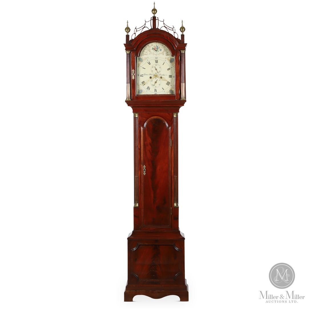 Orkney Quebec Tall Case Clock: Canadian. Wood. A Quebec longcase clock by James Orkney (1760-1832) with the classic fretwork crest on the hood, bracket base, original brass works, and a mahogany veneer case. The arched hood has
