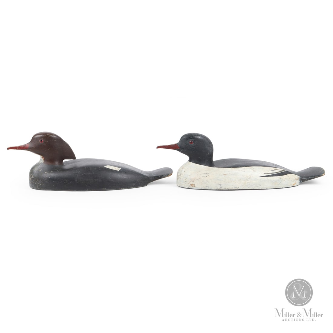 American Merganser Decoys: Eastern Seaboard. 1950s. Painted wood. Female: 6" x 18.5" x 6.75". Male: 6" x 19.25" x 6.75". From the Art and late Shirley Philp Collection. Eastern Seaboard. 1950s.