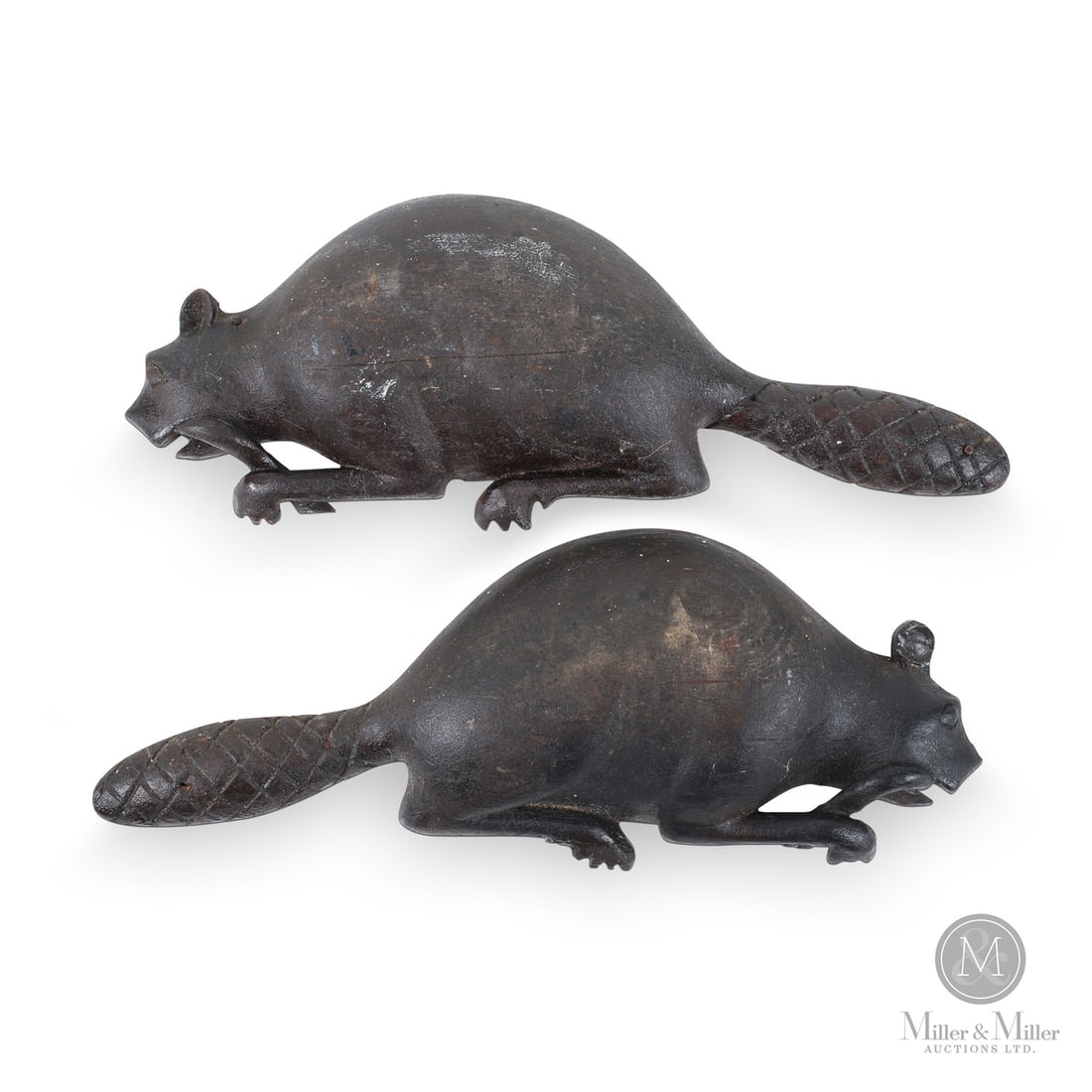 Pair of Carved Beavers: Canadian. Wood. A pair of beautifully carved small-bodied beavers in original dry paint and excellent detail, with hatched tails and each beaver gnawing on a branch. One faces left, the other right, p