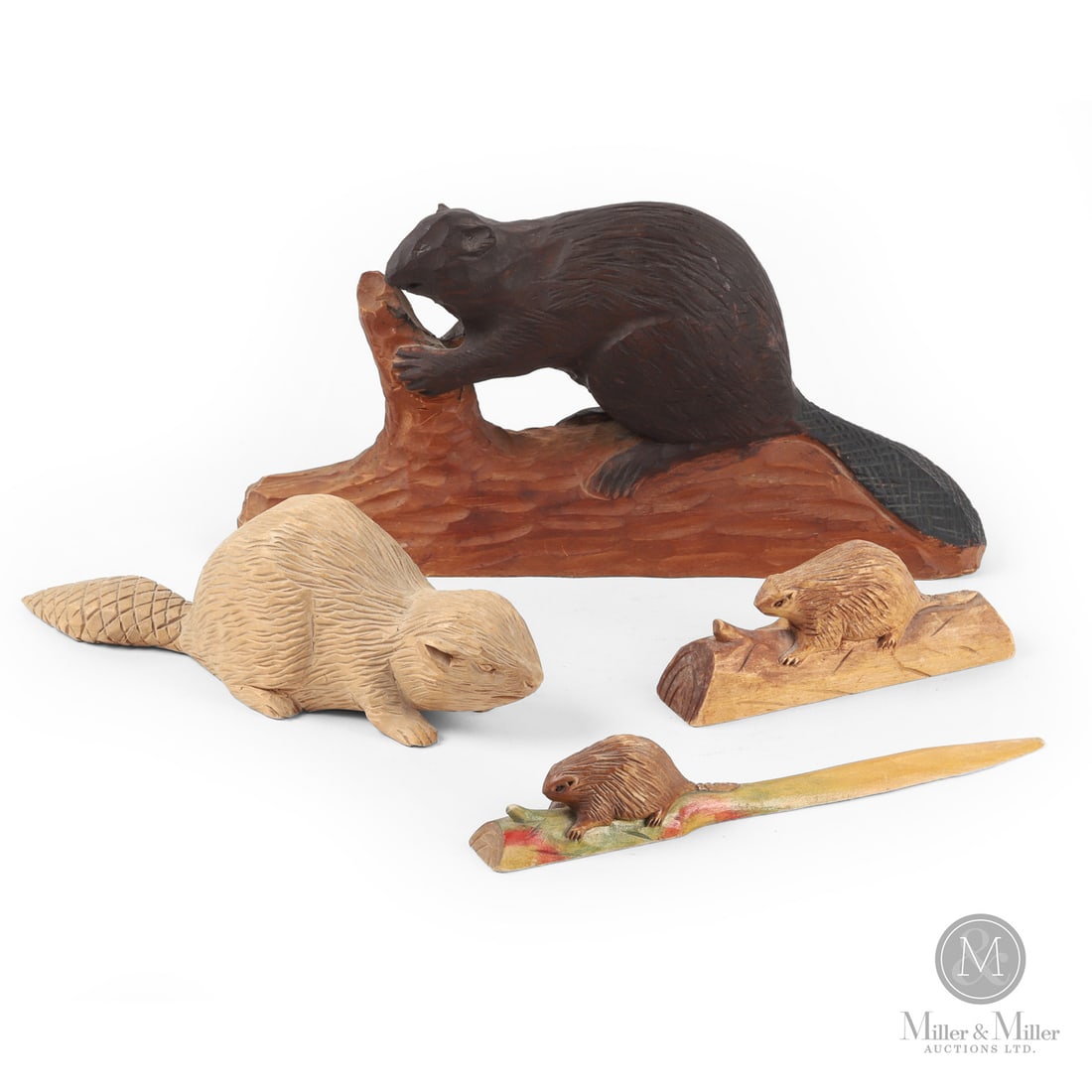 Four Quebec Carved Beavers: Canadian. Wood. Lot of four beaver items: a carved full-bodied beaver on a log in original paint, marked in pen, "1967 Port-Joli Que"; a free-standing full bodied beaver in natural unpainted surface