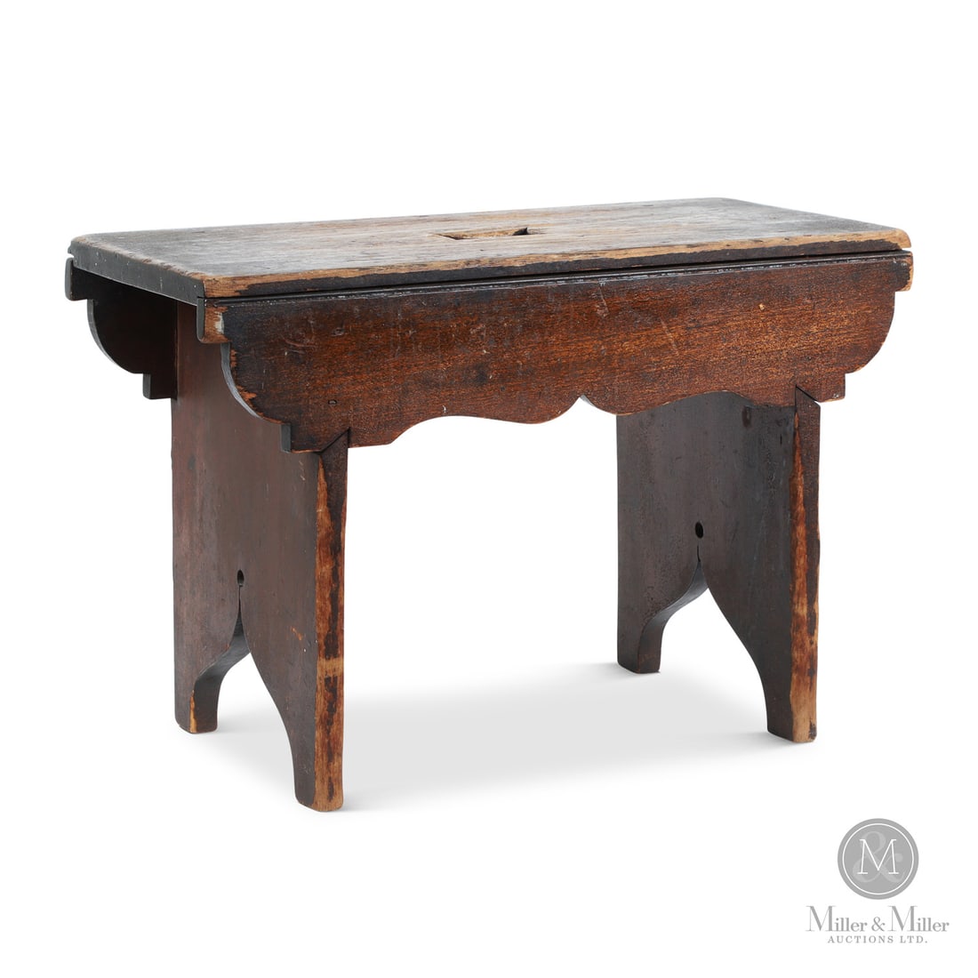 Bench With Scalloped Skirt: Canadian. Wood. A small bench in original dry surface with a nicely shaped skirt, bootjack sides, and a cut-out hand hold in the top. In cherry, very good condition, square nails, uniform wear to edge