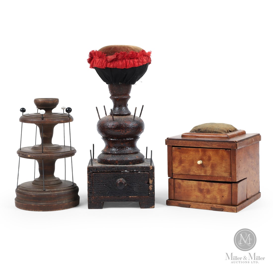 Lot of Lunenburg Spool Holders/Pin Cushions: Canadian. Wood. A lot of three spool holders/pin cushions: a turned shaft example with a drawer in great crackled varnish surface and having a red velvet pin cushion; a two-tier example with hat pins
